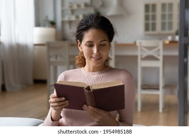 Fond Of Reading. Intelligent Hispanic Woman Take Break To Read Old Vintage Volume Of Classic Literature. Focused Young Lady Reader Having Pleasure To Enjoy Rare Antiquarian Book Of World Famous Author