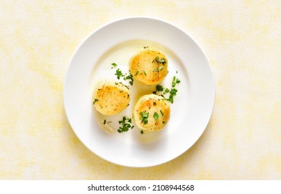 Fondant Potatoes On Plate Over Light Background. Top View, Flat Lay