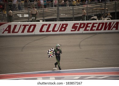 FONTANA, CA - MAR 23: Kyle Busch Picked Up The Checkered Flag After Winning The Nascar Sprint Cup Auto Club 400 Race At Auto Club Speedway In Fontana, CA On March 23, 2014