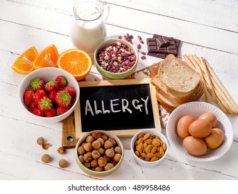 Food allergy. Allergic food on  wooden background. View from above