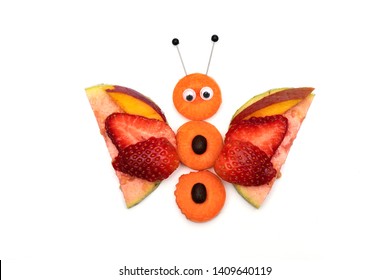 Food art creative concepts. Cute butterfly made of fruits, guava, mango, strawberry and carrots isolated on white background. Top view. - Powered by Shutterstock