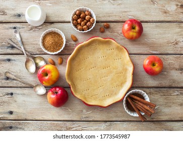 Food Background With  Cooking Tray With Crust, Red Apples And Baking Ingredients On Natural Wooden Background. Flat Lay. Copy Space