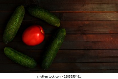 Food Background With One Tomato And Cucumbers Vegetables, Copyspace.Top View.Vegan Diet Concept.