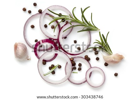 Food background of onion rings, peppercorns, rosemary and garlic cloves, isolated on white.  Overhead view.