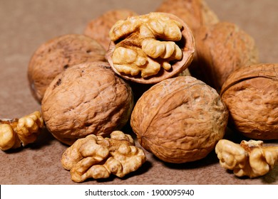 Food background. Walnut kernels close-up. Chopped nuts lie on a wooden table.