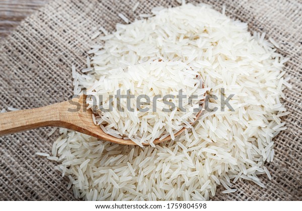 food\
background. white rice in a wooden spoon. top\
view