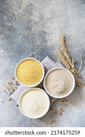 Food and baking gluten free ingredient. Cereals and flours coarse, corn flour, buckwheat flour, chickpeas flour over gray stone background. View from above. - Shutterstock ID 2174175259