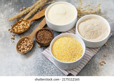 Food and baking gluten free ingredient. Cereals and flours coarse, corn flour, buckwheat flour, chickpeas flour over gray stone background. Copy space. - Shutterstock ID 2175112165