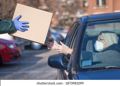 Food Bank Box Handed To Needy Elderly Person In Vehicle