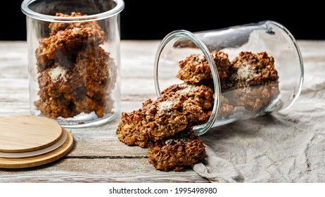 Food banner. Homemade healthy gluten-free oatmeal cookies in glass jars. Healthy food or fitness snack. Oats, isolated milk proteins, dried fruits. Sugarless. Weight control and proper nutrition