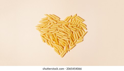 Food Banner And Valentine Concept. Pasta In Shape Of Heart On Light Pink Background.