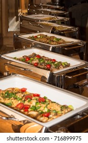 Food Banquet Table With Chafing Dish Heaters On A Festive Event - Selective Focus On Food In One Heater