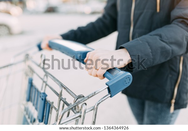 Food basket and the girl's hands. Trolley
for shopping products in the supermarket.
