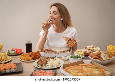 Food Blogger Eating At Table Against Beige Background. Mukbang Vlog