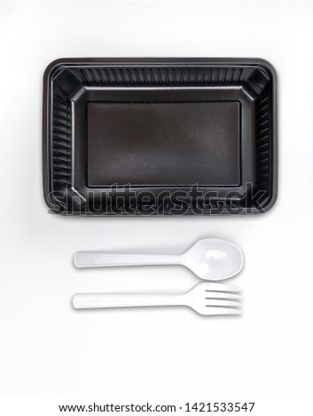 Food box, packaging for delivery or take away, Black plastic box with white fork and spoon set on isolate white background, pen tool die-cut with path for design element and copy space