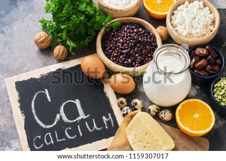 Food with calcium. A variety of foods rich in calcium. Signboard with the word-calcium. Top view