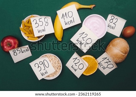 food with calorie value labels. A concept showing calorie counting and taking care of your figure. Effective diet