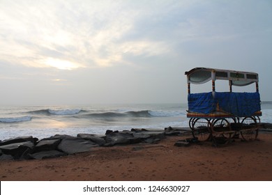 A Food Cart Parked On The Rocky Beach At Sunrise In Puducherry  