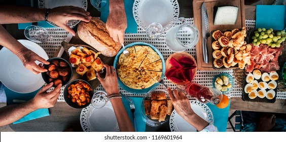 Food Catering Cuisine Culinary Gourmet Buffet Party Concept With Lot Of Hands Taking Food From Various Mixed Place On The Table. Having Fu. Community Leisure Activity At Home Or Restaurant