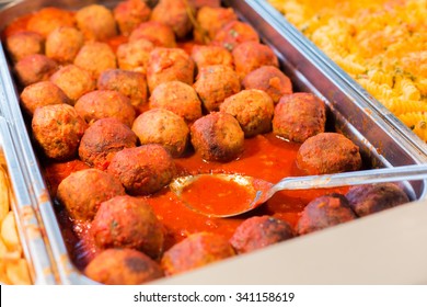 Food, Catering, Self-service And Eating Concept - Close Up Of Meatballs And Other Dishes On Metallic Tray