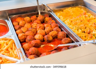 Food, Catering, Self-service And Eating Concept - Close Up Of Meatballs And Other Dishes On Metallic Tray