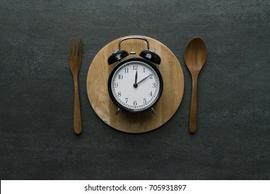 Food Clock At Lunch Time. Healthy Food Concept On Wooden Table