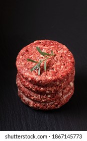 Food Concept Ground Beef Or Hamburger Beef Patty Stack On Black Slate Board With Copy Space