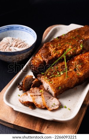 Food concept Homemade Char siu Cantonese style of barbecued pork on blackslate stone background with copy space