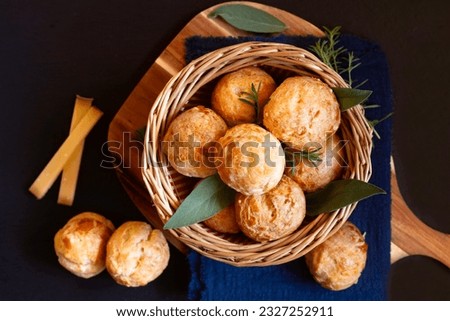 Food concept Spot focus French savory choux pastry gougère, gougeres on black background with copy space