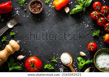 Food cooking background on black stone table.