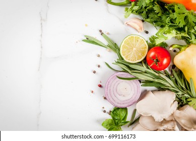 Food cooking background, white marble table. Fresh raw organic vegetables (tomatoes, peppers, mushrooms, onion), herbs, spices, lime for preparation dinner. Top view copy space