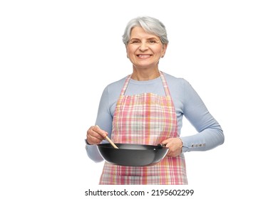 Food Cooking, Culinary And Old People Concept - Portrait Of Smiling Senior Woman In Kitchen Apron With Frying Pan Over White Background