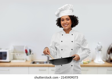 Food Cooking, Culinary And People Concept - Happy Smiling Female Chef With Frying Pan Over Kitchen Background