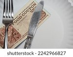 Food coupon on a paper plate with fork and knife
