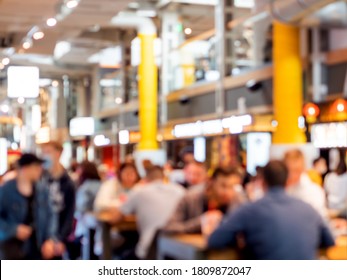 Food Court At Shopping Mall. People Are Eating Without Protective Masks And Social Distance. New Normal Situation After End Of Coronavirus COVID-19 Pandemia. Blurred Background.