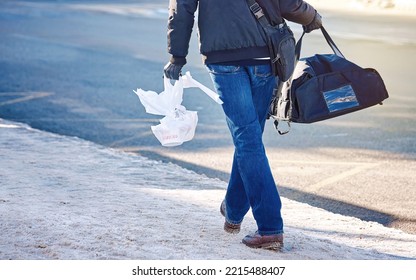 Food Deliver Service. Delivery Man Walk On Snowy Street, Hold Bag With Pizza And Asian Takeout Box In Hand. Delivering Food. Delivery Courier, Boy With Thermal Bag Delivering Food In Winter Day.