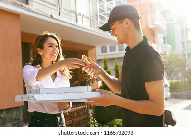 Food Delivery. Courier Delivering Pizza To Client Home