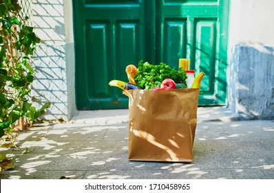 Food Delivery During Coronavirus Outbreak. Paper Bag With Grocery Order In Front Of The Door In Paris, France During Covid-19 Epidemic. Safe Online Shopping, Food Donation Or Takeout Meal Concept