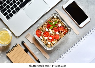 Food Delivery. Lunch Box With A Diet Lunch Or Breakfast Or Dinner On Grey Office Table. Takeaway Lunch At The Office. Top View . Takeout Healthy Lunch. Selective Focus