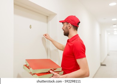 Food Delivery, Mail And People Concept - Man Delivering Pizza In Paper Boxes To Customer Home And Knocking On Door