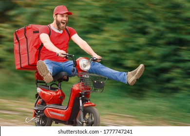 A food delivery man on a red moped with a food delivery bag flies at high speed with his legs spread out to the sides.