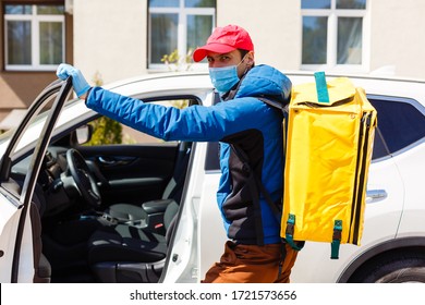 Food Delivery Man In A Protective Mask And Gloves With A Thermo Backpack Near A Car During The Quarantine Period