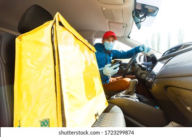 Food Delivery Man In A Protective Mask And Gloves With A Thermo Backpack Near A Car During The Quarantine Period