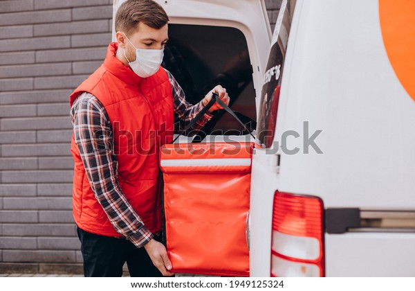 Food delivery\
man putting food box into a\
car