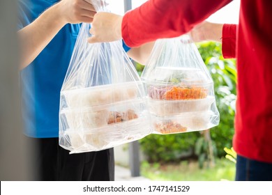 Food Delivery Man Wearing Mask Handling Plastic Bags Shopping Online From Supermarket To Female Client Service Customer Front House, Express Grocery When Coronavirus Crisis.