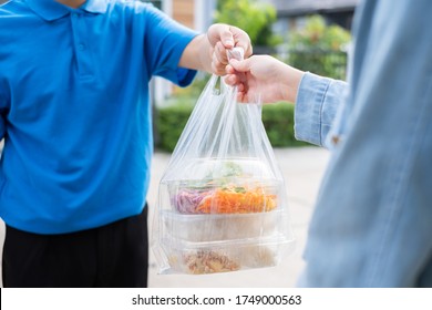 Food Delivery Man Wearing Mask Handing Plastic Bags Shopping Online From Supermarket To Female Client Service Customer Front House, Express Grocery When Coronavirus