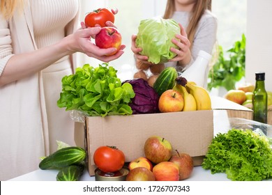 
Food Delivery. Mom And Daughter Unpack A Box Of Vegetables And Fruits. Online Order From The Grocery Store