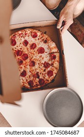 Food Delivery. Ordering Dinner Online From The Restaurant. New York Style Pizza And Movie Night. Family Meal At Home. Pepperoni And Cheese Topping. Cardboard Box. Friday Party. Comfort Food.