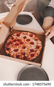 Food Delivery. Ordering Dinner Online From The Restaurant. New York Style Pizza And Movie Night. Family Meal At Home. Pepperoni And Cheese Topping. Cardboard Box. Friday Party. Comfort Food.