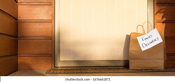 Food delivery in paper bag at door of home for self isolation banner coronavirus recovery - Shutterstock ID 1676661871